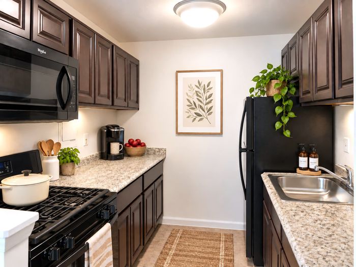 Kitchen with espresso cabinets and black appliances