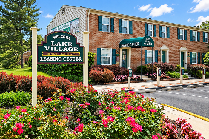 Lake Village Apartments community exterior with landscaped entrance