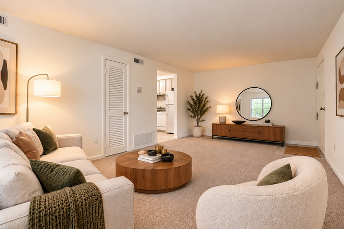 Park Crescent Apartments living room with carpeted floors, comfortable seating, and natural light