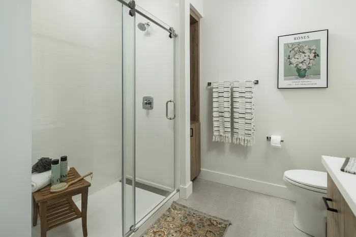 Contemporary bathroom with glass shower, stylish decor, and modern amenities.