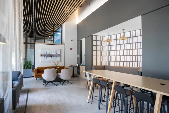 Modern lounge area with chic seating, contemporary decor, and high ceilings for a stylish and inviting atmosphere.