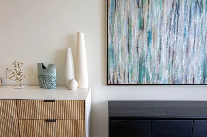 Elegant modern interior featuring an abstract painting, stylish geometric decor, and sleek furniture for a sophisticated aesthetic.