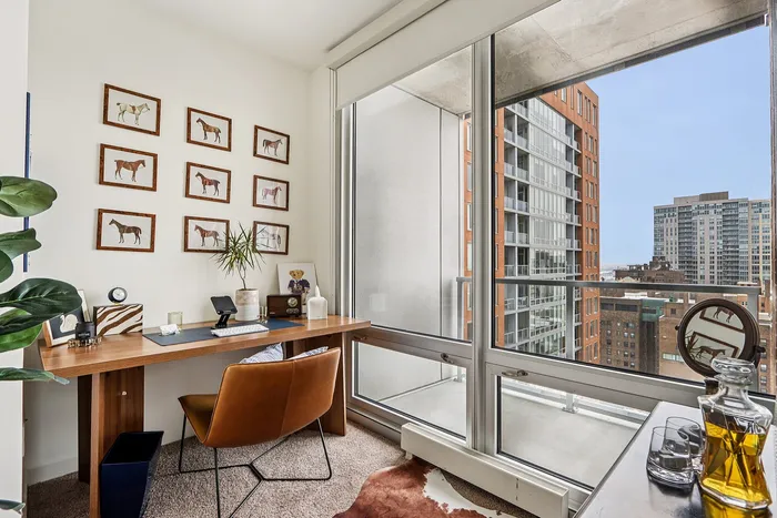 Chic home office with a stunning city view, featuring a stylish wooden desk, contemporary chair, and elegant wall art.