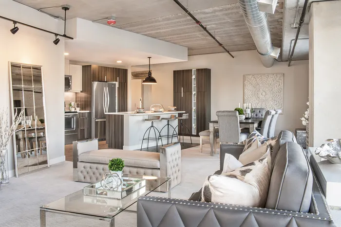 Contemporary open-concept living and dining area with stylish decor, featuring a modern kitchen and elegant furnishings.