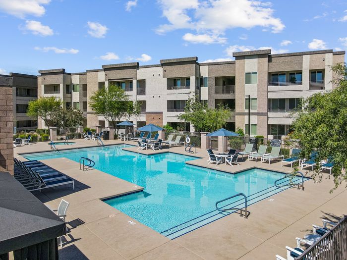 One-BR Apartments In North Phoenix, AZ - Acero North Valley - Swimming Pool With Tanning Chairs, Tables, Umbrellas, And Hot Tub