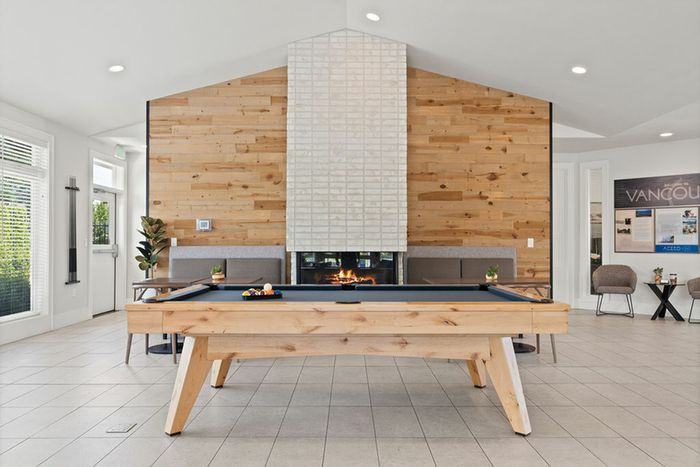 Apartments for Rent in Vancouver, WA - Acero Jensen Park - Gameroom/Clubhouse with Wood and White Walls, LArge Windows, Fireplace, and a Billiards Table