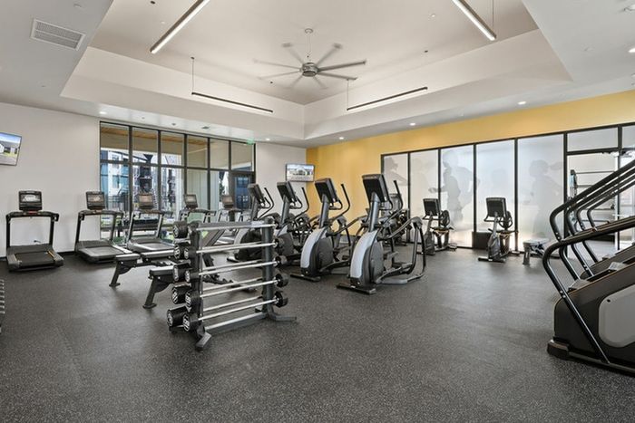 Dog-Friendly Apartments in Vancouver, WA - Bennington on First - Fitness Center with Free Weights, Elliptical Machines, Treadmills, Stationary Bikes, Floor-to-Ceiling Windows, and Ceiling Fan