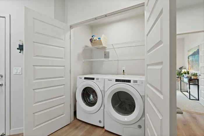 Vancouver, WA Apartments - Bennington on First - Washer & Dryer Inside A Closet With A Storage Rack