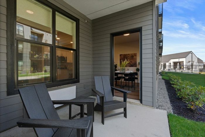 2 BR Apartments in Vancouver, WA - Bennington on First - Exterior View of Building with Parking Lot, Trees, and Landscaping.