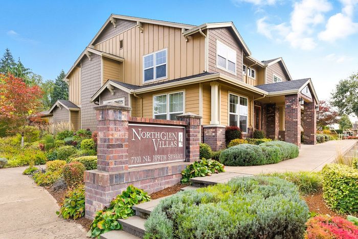 Charming North Glen Villas showcasing beautiful landscaping and welcoming architecture in a serene neighborhood.