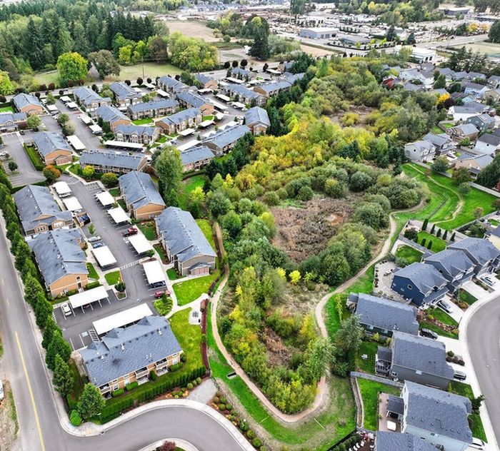 Charming residential community with modern townhouses surrounded by lush greenery and scenic walking paths, offering a perfect blend of nature and suburban living.