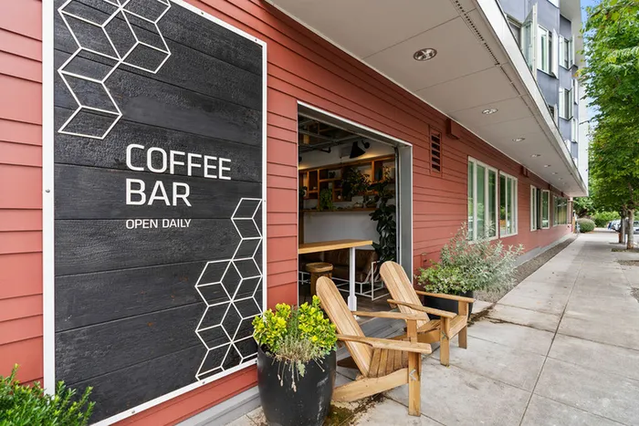 Good Coffee, a charming coffee bar with inviting outdoor seating, nestled next to Division Street Lofts