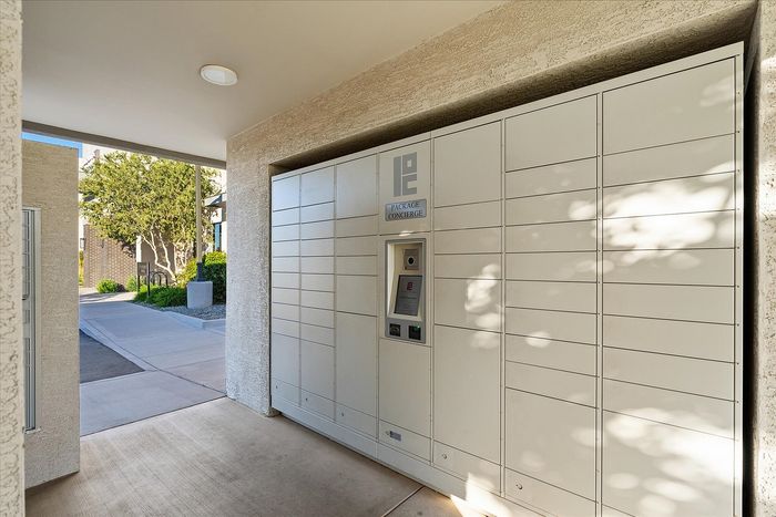 Modern package locker system in a well-lit, secure apartment complex entryway, providing convenience and safety for residents.