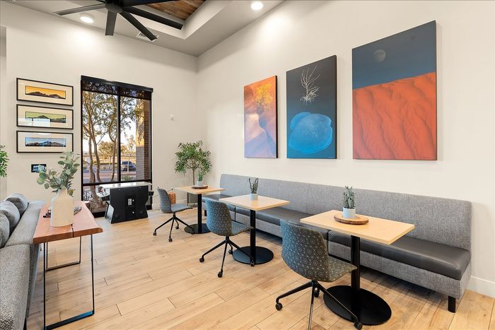 Modern communal seating area with stylish artwork, cozy sofas, and natural light creating an inviting ambiance.