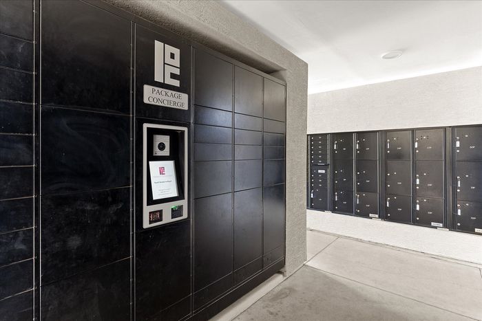 Modern package concierge area with sleek black lockers providing secure and convenient parcel storage.
