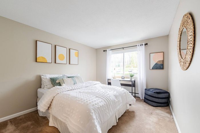 Roomy, comfortably carpeted bedroom offering plenty of space to relax at our welcoming apartments in Dracut, MA. | Princeton Reserve | Apartments in Dracut MA