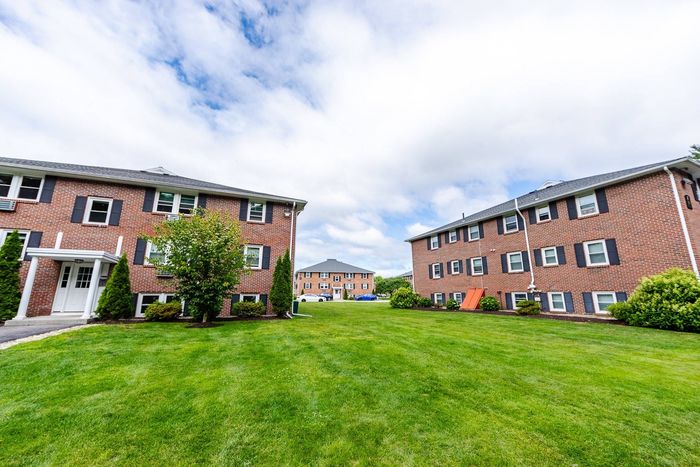 Spend time outdoors in our beautifully designed fenced-in courtyard with seating areas perfect for relaxation and social activities. | Princeton Dover Apartments | Apartment in Dover, NH