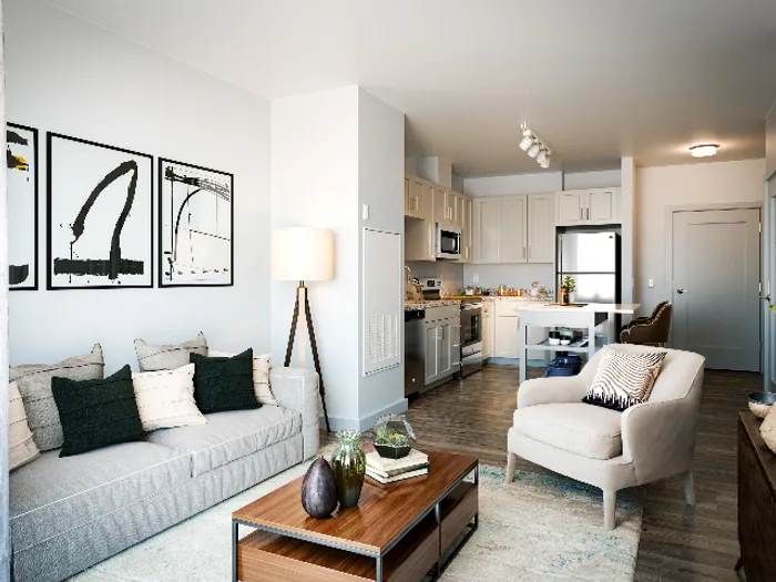 The pleasant living room creates a warm and comfortable atmosphere perfect for daily relaxation.  | The Chandler | Apartment in,Bedford NH