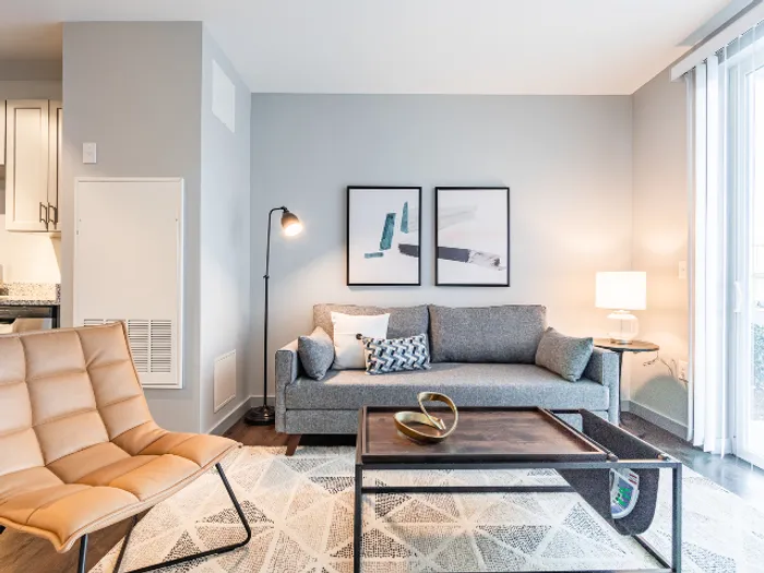 The well-proportioned living room offers versatile space for relaxation, entertainment, and personal expression. | The Chandler | Apartment in,Bedford NH