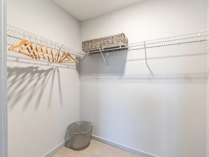 Organize your clothing and accessories with ease in the expansive, beautifully designed walk-in closet at our pet-friendly apartments in Bedford, NH. | The Chandler | Apartment in,Bedford NH