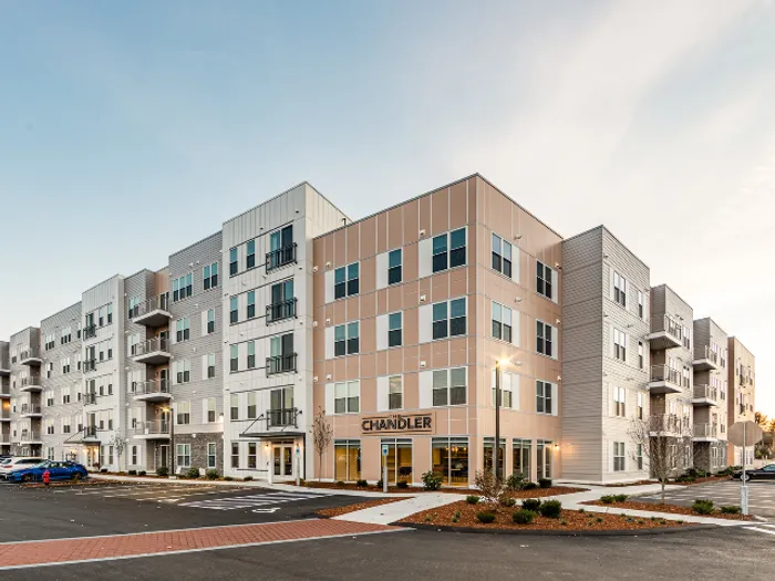 The beautifully maintained building exterior creates a warm and welcoming atmosphere perfect for your daily arrival home at our premium apartments in Bedford, NH. | The Chandler | Apartment in,Bedford NH