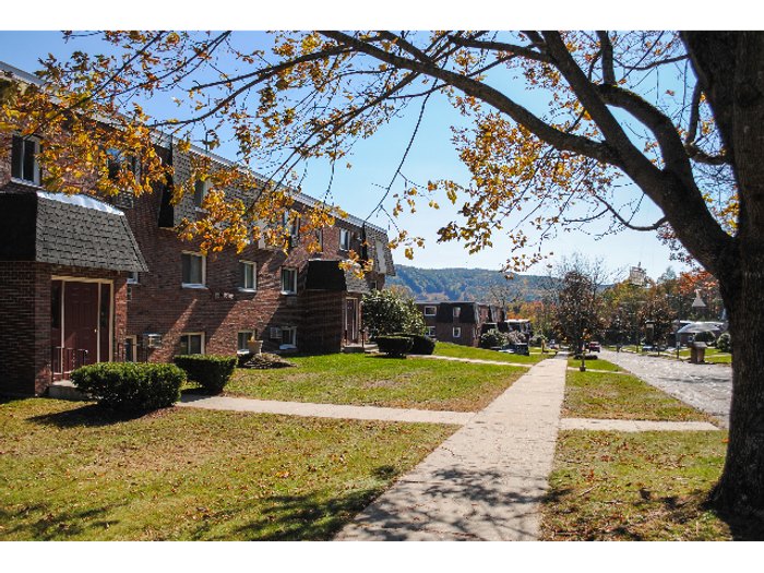 Sidewalks and entrances to apartments at Princeton Commons apartment community in Claremont, NH.