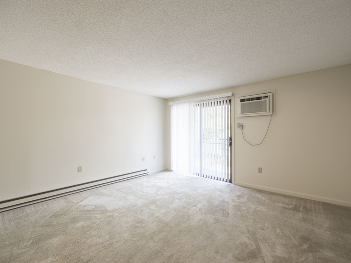 Roomy living area with sliding doors and AC unit  | Princeton Place | Apartments For Rent Near Worcester MA
