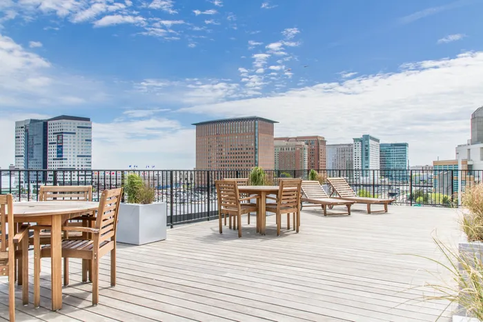 Relax, entertain, and enjoy breathtaking, sweeping skyline views from the building's stunning roof deck. | 381 Congress Lofts | Apartments For Rent in Boston