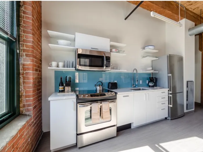 Your spacious kitchen offers generous square footage with room for multiple people and all your cooking essentials. | 381 Congress Lofts | Apartment in, Boston MA