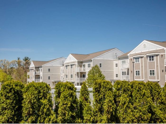 Beautiful exterior view of the landscaped grounds and building facades at our welcoming apartments in Dracut, MA. | Princeton Reserve | Dracut apartments for rent