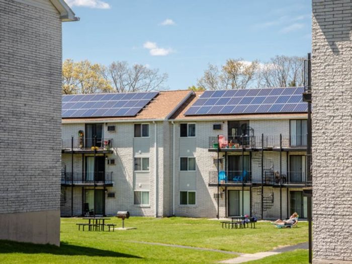 Explore the beautiful building exterior and lush surroundings at our scenic apartments in Dracut, MA. | Princeton Reserve | Dracut apartments for rent
