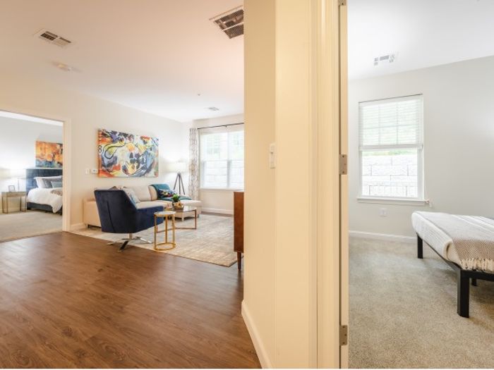 Spacious living room between two bedrooms at Mill & 3 Apartments in Chelmford, MA.