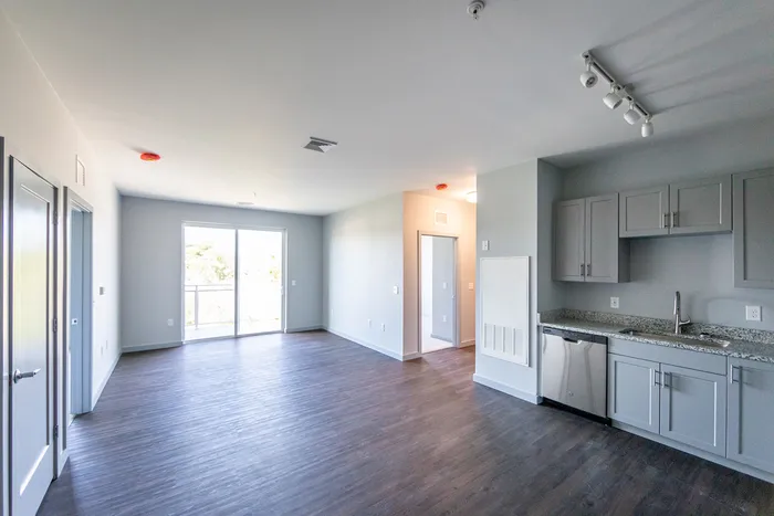 The pleasant living room creates a warm and comfortable atmosphere perfect for daily relaxation.  | The Chandler | Apartment in,Bedford NH