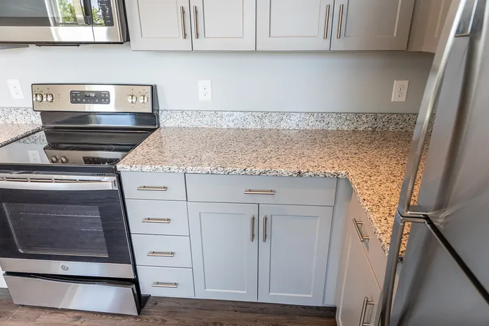 Close up showing details of the kitchen including appliances, cabinetry, and counter tops in the kitchen at an apartment at The Chandler | New Apartments in Bedford, NH.