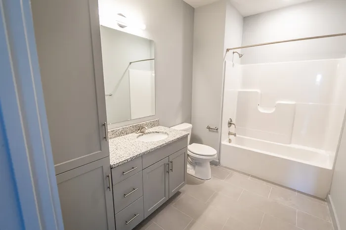 Your light-filled principal bathroom offers refreshing space with natural light and comfortable proportions. | The Chandler | Apartment in,Bedford NH