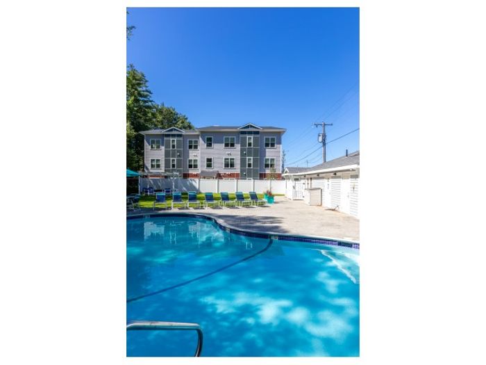Dive into relaxation at our resort-style pool featuring crystal-clear water, comfortable lounging areas, and beautiful surroundings. Your aquatic escape. | Princeton Dover Apartments | Princeton Dover Apartments