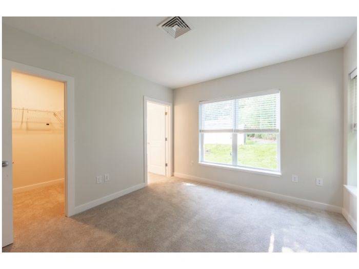 The primary bedroom with walk-in closet offers generous storage space and comfortable sleeping area. | Princeton Dover Apartments |