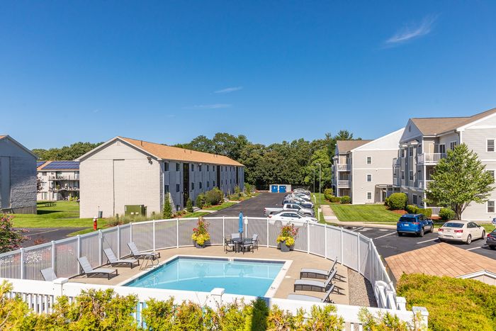 Spend your summer days lounging beside the pristine, resort-style swimming pool at our scenic apartments in Dracut, MA. | Princeton Reserve | Apartments For Rent Dracut MA