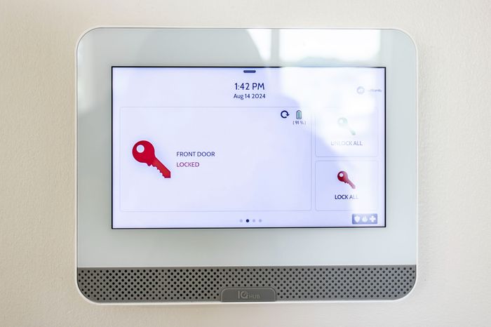 The James Apartments | Touchscreen home ADT security system panel displaying the status of the front door as locked | Luxury Apartments in Haverhill MA