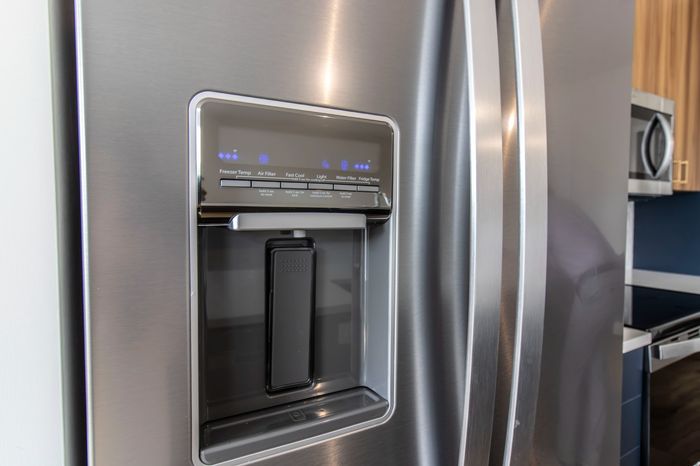 The James Apartments | Close-up of a stainless steel refrigerator with a built-in water and ice dispenser, featuring control settings | Luxury Apartments in Haverhill MA