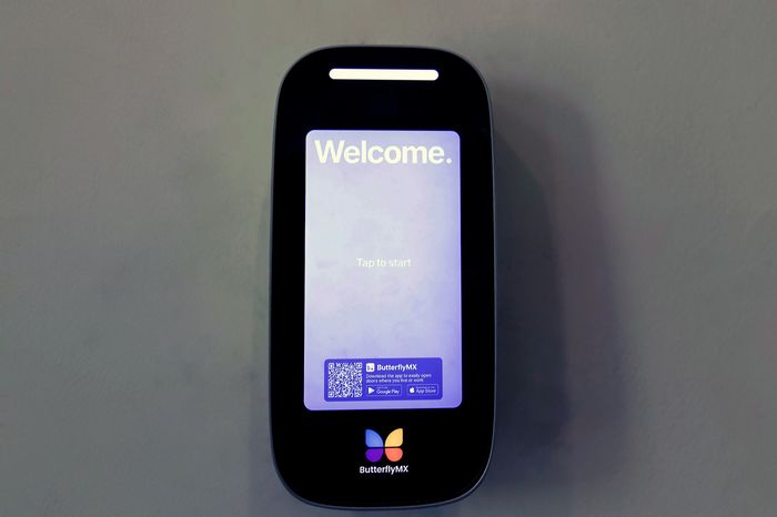 The James Apartments | Close-up of the ButterflyMX smart intercom system displaying a welcome screen with an option to tap and start | Luxury Apartments in Haverhill MA
