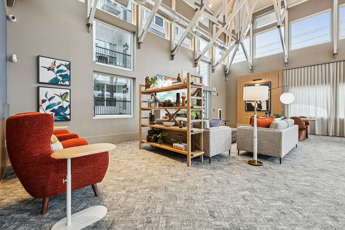 Bright, open lounge area with modern furniture and high ceilings.