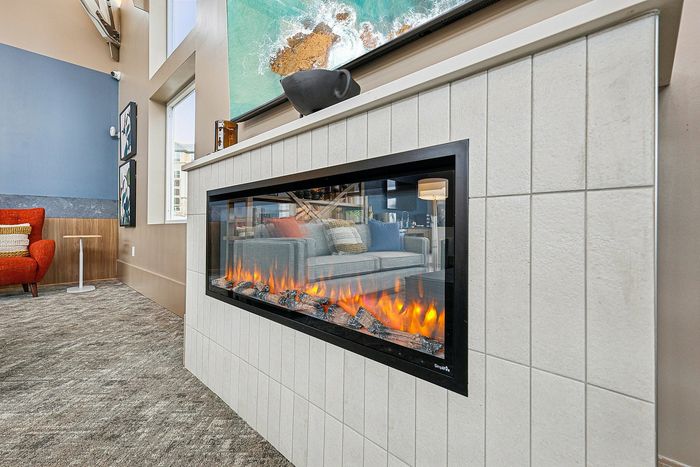 Modern living room with a sleek fireplace and vibrant decor.