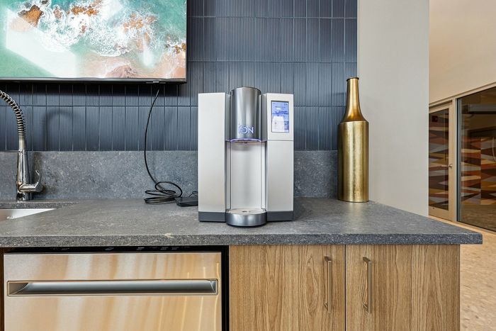 Modern kitchen counter with a stainless steel water dispenser and elegant decor.
