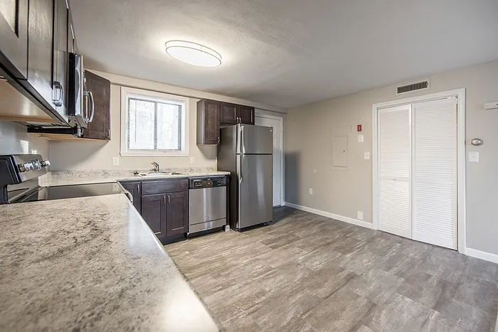 Bright and modern kitchen featuring sleek stainless steel appliances, elegant granite countertops, and ample cabinetry.
