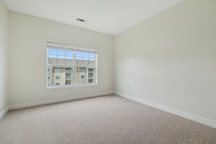 Envision your perfect layout in this bright, open-concept carpeted room offering plenty of natural light and flexible space at our scenic apartments in Westford, MA. | Princeton Westford Apartments | Apartments with Balcony in Westford