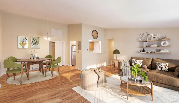 Elegant and cozy living room with warm wooden flooring, a stylish brown sofa adorned with chic cushions, and a contemporary dining area featuring vibrant green chairs and a modern table.| The Royal Crest | Apartment in North Andover, MA