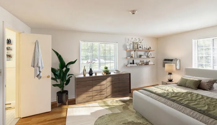 Inviting bedroom with large windows, elegant decor, and lush indoor plant, enhancing the cozy atmosphere of this stylish apartment.| The Royal Crest | Apartment in North Andover, MA