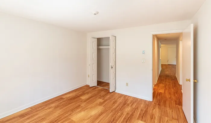 Bright and airy room with pristine wood flooring, ample closet space, and a contemporary hallway view, perfect for comfortable living.Your spacious kitchen offers generous square footage with room for multiple people and all your cooking essentials. | The Royal Crest | Apartment in,North Andover MA