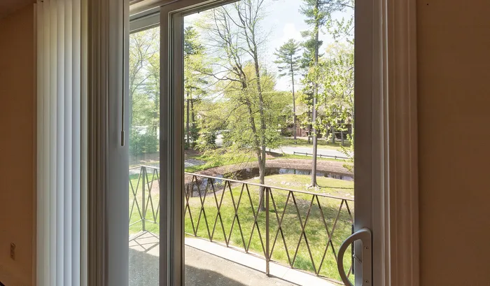 Inviting balcony view with lush green trees, perfect for relaxation and enjoying nature.Your spacious kitchen offers generous square footage with room for multiple people and all your cooking essentials. | The Royal Crest | Apartment in,North Andover MA